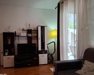 a living room with a tv and a couch at Macy in Kotor