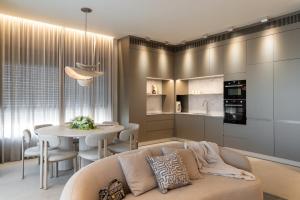 a living room with a couch and a table at Alma Eilat Garden Apartment with Private Pool in Eilat