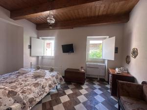 a bedroom with a bed and a tv on the wall at DeD Palace Tivoli in Tivoli