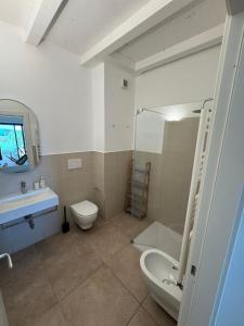a bathroom with a toilet and a sink and a shower at YCH-Ovile Country Home in Carige Bassa