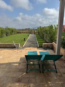a patio with a table and chairs and a pathway at YCH-Ovile Country Home in Carige Bassa +37 photos