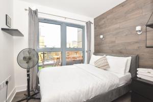 Un dormitorio con una cama blanca y una ventana. en Big Ben 2 Bed, en Londres