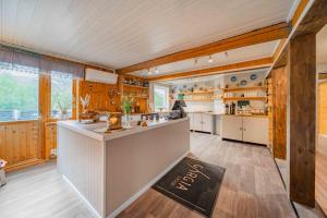 a large kitchen with a counter in a house at Gargia Lodge in Alta