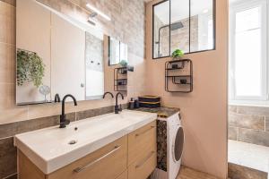 a bathroom with a sink and a washing machine at Le Louis XV Halte à Reims centre in Reims +24 photos