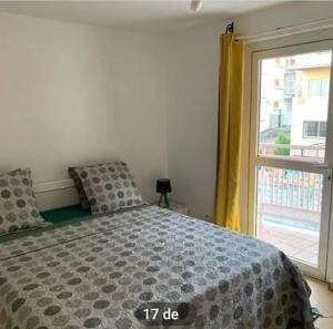 a bedroom with a bed and a large window at Villa Soazara in Koungou