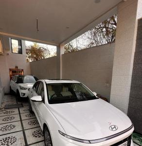 a white car parked in front of a garage at Shanti vilas in Jaipur +24 photos