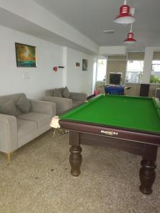 a living room with a pool table and a couch at Anant in Jāmb