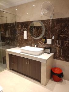 a bathroom with a sink and a mirror at Anant in Jāmb