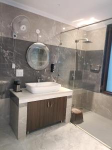 a bathroom with a sink and a shower at Anant in Jāmb +5 photos