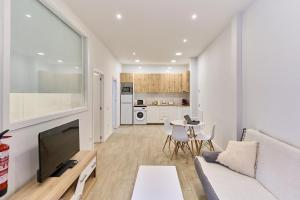 a living room with a couch and a table at Paraíso Suites by gaiarooms in Valladolid