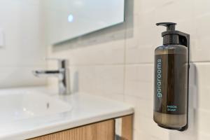 a soap dispenser sitting on a counter in a bathroom at Paraíso Suites by gaiarooms in Valladolid +29 photos