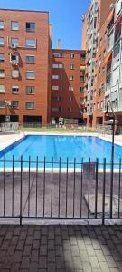 マドリードにあるHabitación Caja Mágicaのいくつかの建物の前にある大きなプール