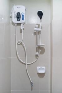 a shower in a bathroom with a hair dryer at Chateau Cinco Near SM Lanang in Davao City