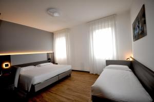 Postel nebo postele na pokoji v ubytování Hotel Igea
