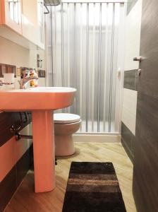 a bathroom with a sink and a toilet and a shower at Casa Sikelia in Marsala +11 photos