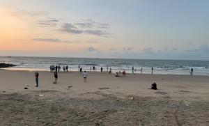 a group of people walking on the beach at Bali Villa- Đối diện Tropicana Park - Novaworld Hồ Tràm in Ho Tram