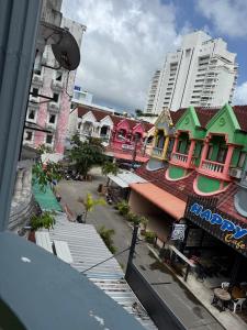 a group of colorful buildings in a city at Sundiva Guest House in Patong Beach