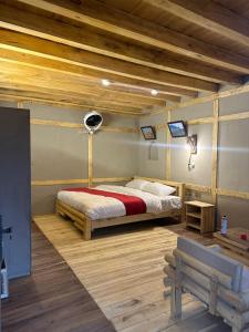 a bedroom with a bed and a wooden ceiling at Zimsa Resort Skardu in Skardu