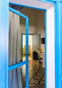 a blue door leading to a room with a desk at Cala Batteria - Camping & Village in Bisceglie