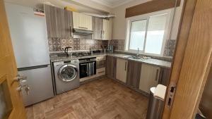 a kitchen with a washer and a sink and a dishwasher at AyaMi Casa in Oued Laou