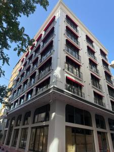 a tall white building with balconies on it at Mandala Karaköy Hotel in Istanbul