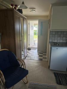 a kitchen with a couch and a chair in a room at Studio Kustvägen in Mellbystrand