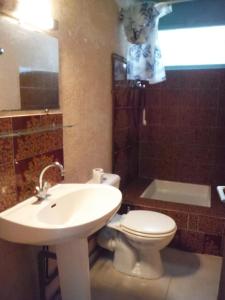 a bathroom with a sink and a toilet and a sink at Camping Europa Beach in Castellare-di-Casinca +27 photos