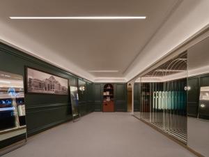 a hallway in a building with green walls and a door at North Bund 681 in Shanghai
