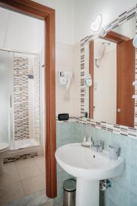 a bathroom with a white sink and a mirror at Central Station by CasaNapoletana in Naples