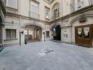 an empty courtyard of a building with a door at Central Station by CasaNapoletana in Naples