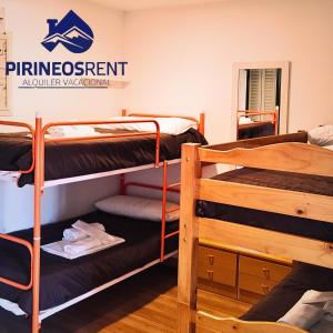 a room with two bunk beds and a sign that reads pineapples exponent authority at Apartamentos Pirineos Rent in Candanchú