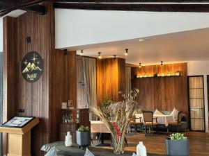 a lobby with wooden walls and a table and chairs at No107 Predeal in Predeal