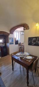 a living room with a wooden table in a room at La Volta Segreta in Albenga