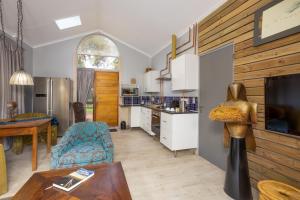 a kitchen and a living room with a table at African Rock Hotel & Spa -"Relaxed Exclusivity" in Kempton Park