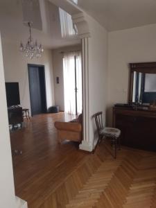 an empty living room with a couch and a chair at Семейныи номер двумя спальнями in K'obulet'i