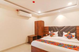 a bedroom with a large bed in a room at RROOMS Rachna Inn in Lucknow