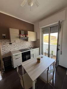 a kitchen with a table with chairs and a counter top at Crisvan Home in Capo Rizzuto +36 photos