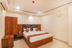 a bedroom with a large bed in a room at RROOMS Rachna Inn in Lucknow
