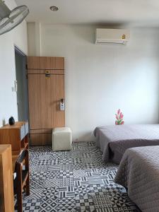سرير أو أسرّة في غرفة في Merit Courtyard Suvarnabhumi House