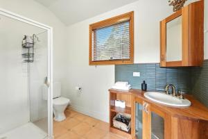 a bathroom with a sink and a toilet at Countryside Escape Near Margate Village in Margate
