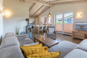a living room with a couch and a table at Ferienhaus - Sylt in Dagebüll