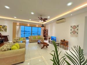 a living room with couches and a dog in it at Maison life 小居屋 The Loft Imago in Kota Kinabalu