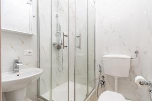 a bathroom with a shower and a toilet and a sink at GuestHost - La Casa di Polly in Bitritto +14 photos