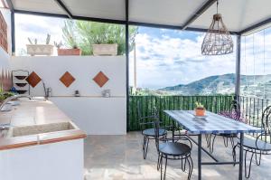 a kitchen and dining room with a table and chairs at Casa Jema in Torrox