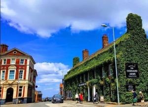 a street with a building with ivy growing on it at Spacious contactor family Apartment in Swindon +7 photos