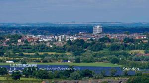 a view of a city with a lake and buildings at Spacious contactor family Apartment in Swindon