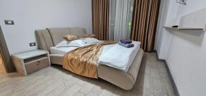 a bedroom with a bed with a teddy bear on it at Mamaia Nord Promenada - Beach Pool si Spa Resort langa plaja in Mamaia Nord +35 photos
