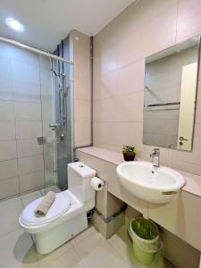a bathroom with a toilet and a sink and a shower at Maison life 小居屋 The Loft Imago in Kota Kinabalu