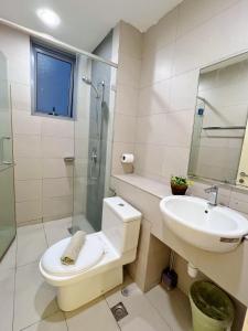 a bathroom with a toilet and a sink and a shower at Maison life 小居屋 The Loft Imago in Kota Kinabalu