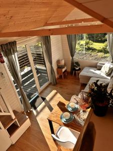 a living room with a couch and a table at Horyzont Spokoju in Podobin +27 photos